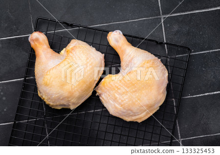 Fresh Raw farm chicken legs ready for cooking, poultry meat on black background, top view Fresh Raw farm chicken legs ready for cooking, poultry meat on black background, top view 133325453