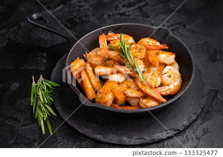 Close up of juicy grilled prawns garnished with herbs, a delicious seafood delight for any gourmet dish. black background. top view Close up of juicy grilled prawns garnished with herbs, a delicious seafood delight for any gourmet dish. black background. top view 133325477