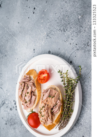 Freshly made tuna salad sandwich on whole grain bread, a nutritious and satisfying meal for any time of day. grey background. top view 133325523