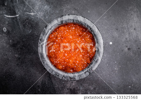 Exquisite salmon roe, vibrant and rich, ideal for adding a touch of elegance to your culinary creations. black background. top view Exquisite salmon roe, vibrant and rich, ideal for adding a touch of elegance to your culinary creations. black background. top view 133325568