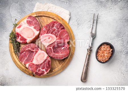 Beautifully marbled raw veal ossobuco, perfect cross cut shank meat for traditional Italian recipes and savory family dinners. white background. top view Beautifully marbled raw veal ossobuco, perfect cross cut shank meat for traditional Italian recipes and savory family dinners. white background. top view 133325570