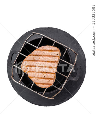 Juicy grilled tuna steak, perfectly seared with a smoky flavor, ideal for seafood lovers and gourmet dishes. isolated on white background. top view Juicy grilled tuna steak, perfectly seared with a smoky flavor, ideal for seafood lovers and gourmet dishes. isolated on white background. top view 133325595