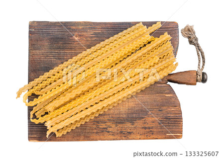 Uncooked mafaldine, ready to be transformed into a delicious dish that highlights its delightful texture. isolated on white background. top view 133325607