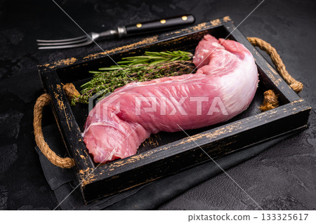 Raw pork tender cut, tenderloin featuring a smooth texture, perfect for creating gourmet dishes at home. black background. top view 133325617