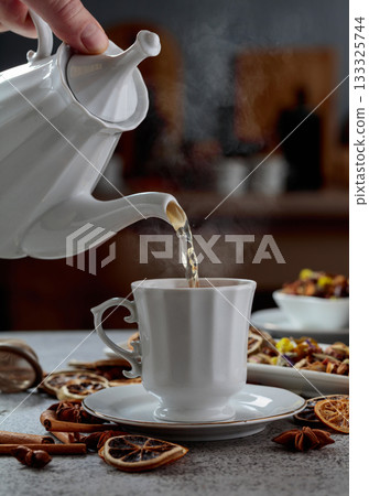Herbal tea is poured into a cup. Herbal tea is poured into a cup. 133325744