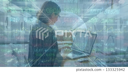 Analyzing professional woman reviewing stock data on laptop at office, with eyeglasses notebook Analyzing professional woman reviewing stock data on laptop at office, with eyeglasses notebook 133325942
