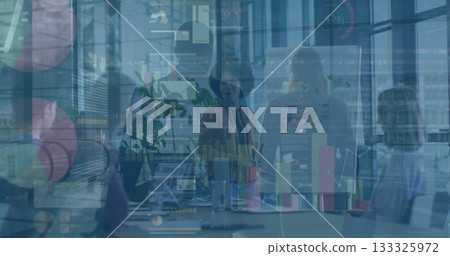 Reviewing data forecasts office team examining charts in conference room, with laptops, flipchart 133325972