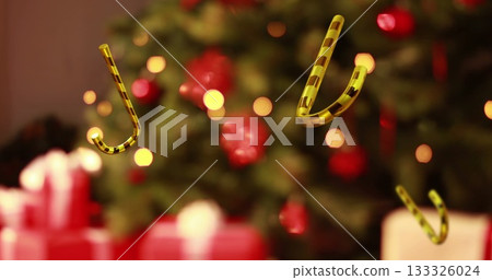 Gold-black candy cane ornaments floating in living room, tree with baubles, lights, gift boxes Gold-black candy cane ornaments floating in living room, tree with baubles, lights, gift boxes 133326024
