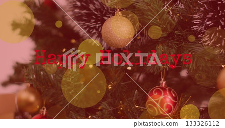 Highlighting Christmas tree at home with glittery decor, lights, bokeh and Happy Holidays overlay Highlighting Christmas tree at home with glittery decor, lights, bokeh and Happy Holidays overlay 133326112