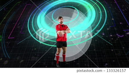 Standing male athlete wearing red sports kit in virtual training space, with holographic rings 133326157