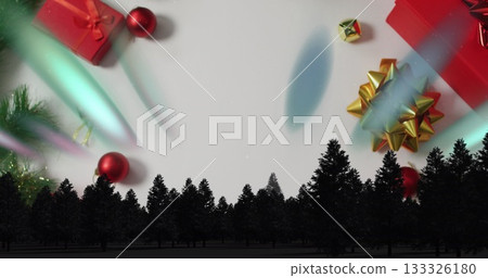 Displaying pine tree silhouette forming horizon on white backdrop, with gift boxes and baubles 133326180