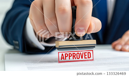 Close up businessman hand stamping red APPROVED text on document official legal paper agreement authorization permission confirmation decision concept formal approval process Close up businessman hand stamping red APPROVED text on document official legal paper agreement authorization permission confirmation decision concept formal approval process 133326469