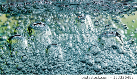 Green water bubbles background for concept of clean liquid, purity, or fresh drink Green water bubbles background for concept of clean liquid, purity, or fresh drink 133326492