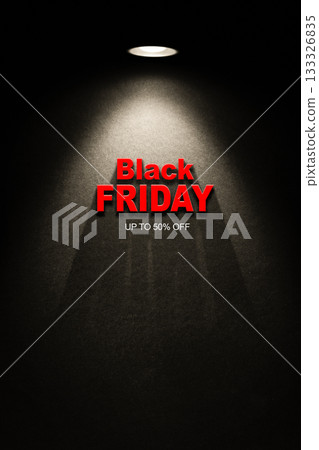 Red Black Friday headline under a spotlight on a dark wall. High-contrast promo background focused on discount messaging. Red Black Friday headline under a spotlight on a dark wall. High-contrast promo background focused on discount messaging. 133326835