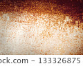 Rusty metal surface with peeling paint forming a warm gradient on white. Industrial grunge background with copy space for banners and restoration topics. 133326875