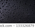 Studio macro of fine droplets on black water repellent texture. Clean premium background for waterproof products, electronics and outdoor branding. 133326879