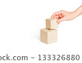 Hand stacks cardboard boxes on a white background. Concept of delivery, packing, online orders and logistics. 133326880