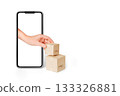 E-commerce concept: hand adds boxes from a smartphone screen. Online order, payment and fast delivery. 133326881