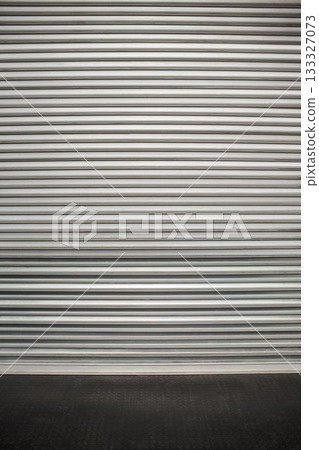 Flat vector metal roll-up shutter door spanning frame, showing ridges, resting on textured floor Flat vector metal roll-up shutter door spanning frame, showing ridges, resting on textured floor 133327073