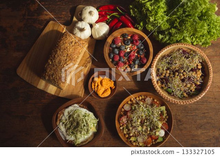 High angle view of bread and berry fruits on table 133327105