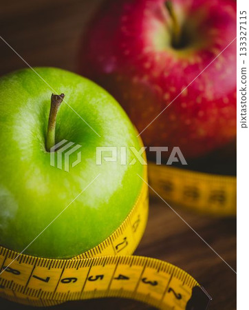 Red and green apples with measuring tape Red and green apples with measuring tape 133327115