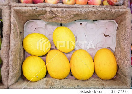 Yellow melon in crate at supermarket 133327284