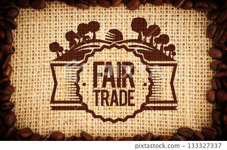 Fair trade emblem is standing out on coarse burlap flat-lay, with coffee beans framing edges Fair trade emblem is standing out on coarse burlap flat-lay, with coffee beans framing edges 133327337