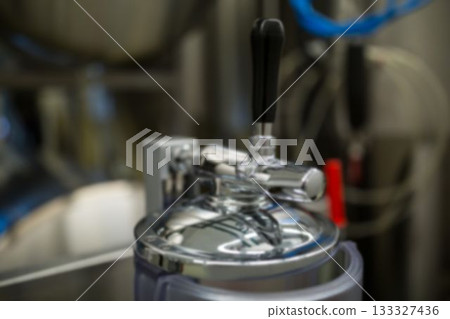 Mettalic handle at distillery still 133327436