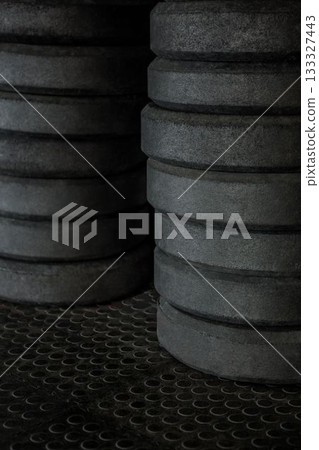 Stack on weight plates in fitness studio Stack on weight plates in fitness studio 133327443