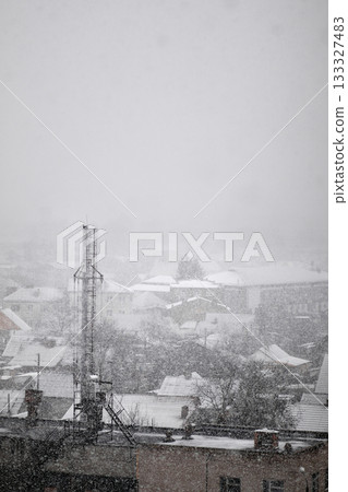 infrastructure during winter in Ukraine. A crucial cell tower stands tall amidst heavy snow, symbolizing the effort to maintain phone and network technology 133327483