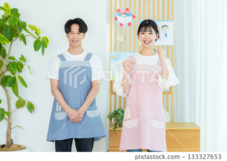 Nursery teacher wearing an apron 133327653