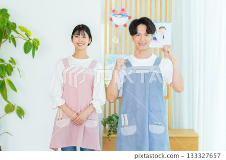 Nursery teacher wearing an apron Nursery teacher wearing an apron 133327657