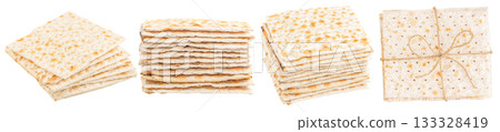 Traditional Israeli matzah bread stacked on white background, unleavened flatbread tied with string, symbol of Jewish culture and Passover holiday, copy space for text 133328419