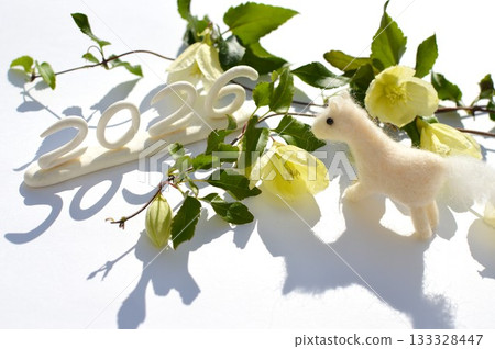 Wool felt white horse and winter-blooming clematis New Year's material 133328447
