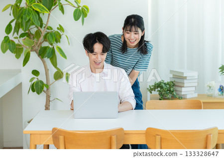 Couple looking at pc Couple looking at pc 133328647