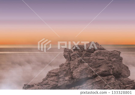 Rugged rock formation is emerging from calm sea in flat design, featuring misty waves, gradient sky Rugged rock formation is emerging from calm sea in flat design, featuring misty waves, gradient sky 133328801
