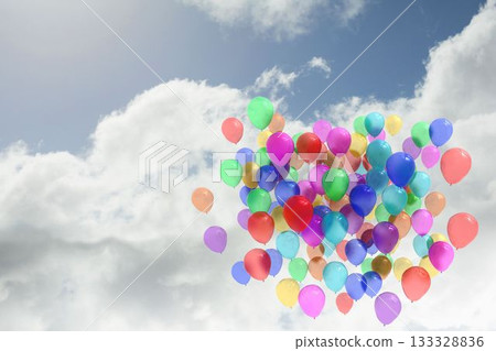 Cluster of multicolored latex balloons rising in partly cloudy blue sky, flat design 133328836