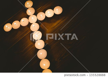 Candles in shape of cross on table 133328888