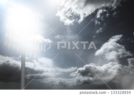 Cloud-filled sky is showcasing sun rays, lens flare and faint pole sign in flat vector illustration Cloud-filled sky is showcasing sun rays, lens flare and faint pole sign in flat vector illustration 133328934