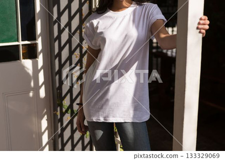 Flat design showing woman leaning on door frame with grid and vine shadows dancing across shirt 133329069
