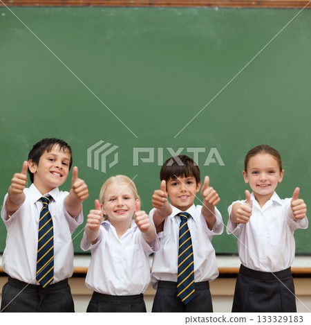 Cute pupils showing thumbs up in classroom Cute pupils showing thumbs up in classroom 133329183