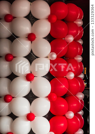 Red and white balloons decorating a wall for wedding reception Red and white balloons decorating a wall for wedding reception 133329364