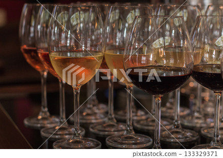 Wine glasses filled with red, white, and rose wine for a wedding celebration 133329371