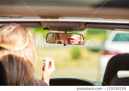 Girl apply make up while driving car. Girl apply make up while driving car. 133330189
