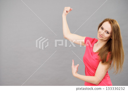 Woman flexing biceps Woman flexing biceps 133330232