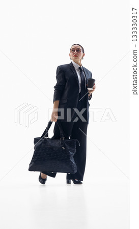 Businesswoman holding coffee and bag with confident relaxed emotion Businesswoman holding coffee and bag with confident relaxed emotion 133330317
