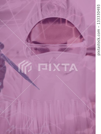 Scientist dropping the reagent into test tube for reaction testing 133330493