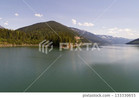 Calm river and mountains against sky 133330655