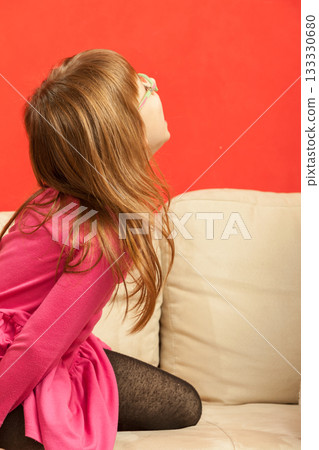 Young toddler girl playing on sofa 133330680
