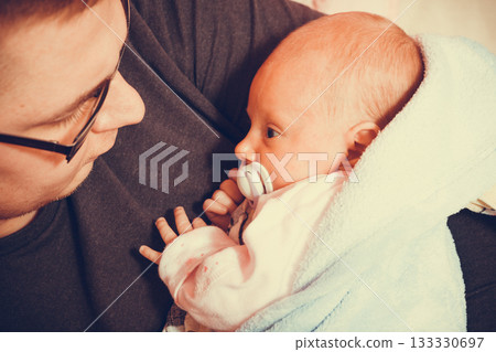 Father holding taking care of newborn baby Father holding taking care of newborn baby 133330697